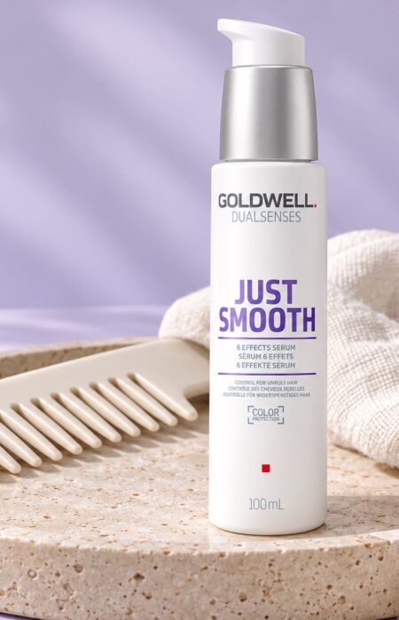 Serum Goldwell Just Smooth 6 Effects 100 ml na kamiennej tacy obok grzebienia