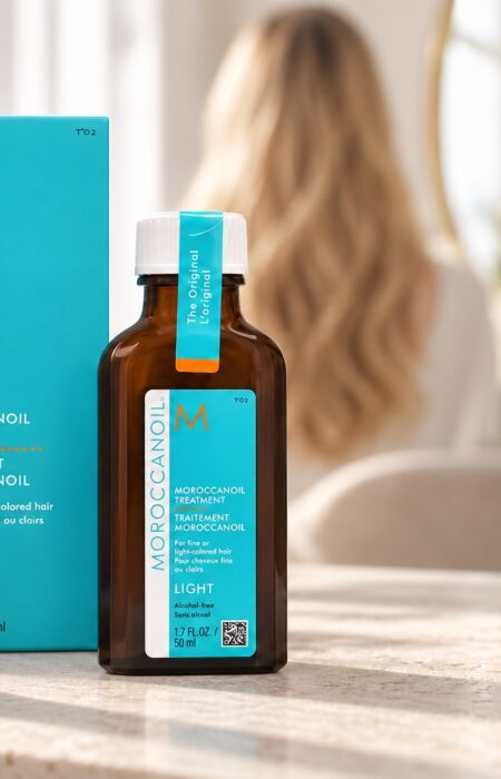 Butelka Moroccanoil Treatment Light 50 ml i turkusowe pudełko na jasnym blacie