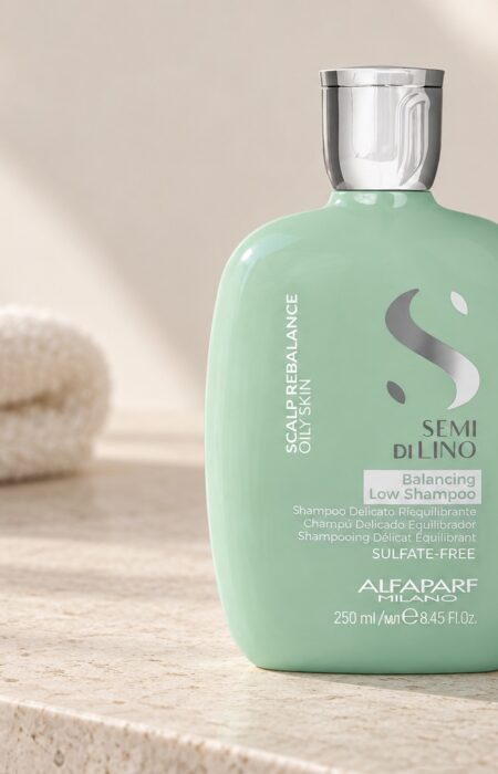 Miętowa butelka Alfaparf Semi di Lino Balancing Low Shampoo 250 ml na jasnej półce