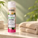 Butelka odżywki Novex Coconut Oil 300 ml na jasnej półce obok ręcznika.